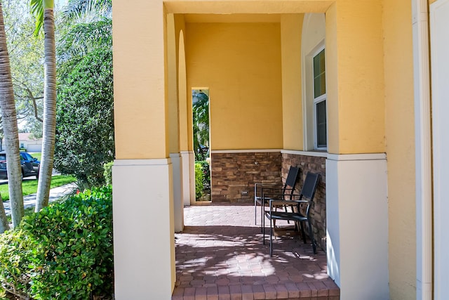 entrance to property with stone siding and stucco siding