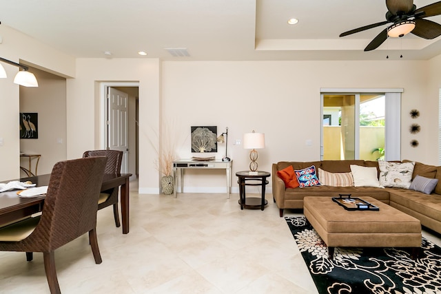 living area with visible vents, recessed lighting, baseboards, and a tray ceiling