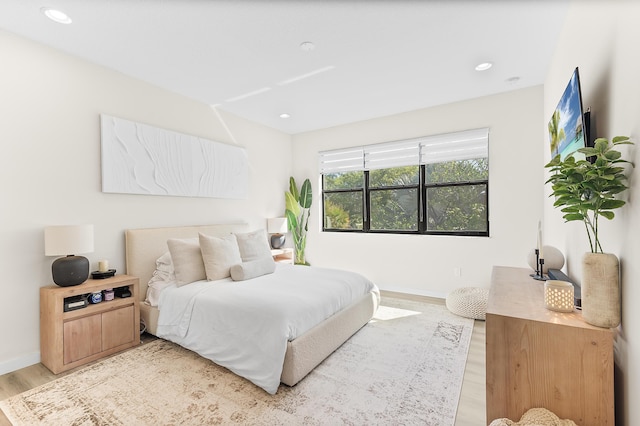 bedroom with recessed lighting, baseboards, and light wood-style floors