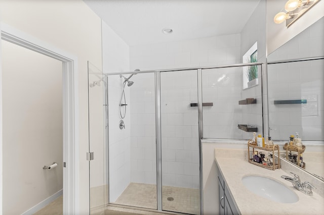 bathroom with a stall shower and vanity