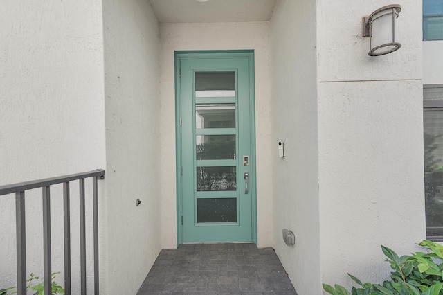 view of exterior entry featuring stucco siding