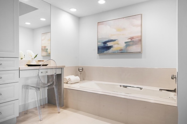 bathroom with a garden tub and recessed lighting