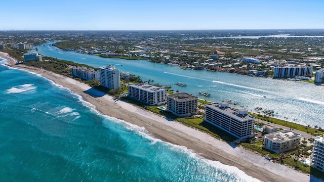 aerial view featuring a water view, a city view, and a beach view