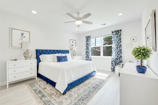 bedroom with recessed lighting, light wood-type flooring, baseboards, and visible vents