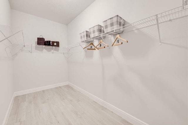 spacious closet with wood finished floors