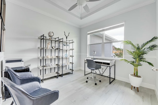 office area with crown molding, a raised ceiling, baseboards, and wood finished floors