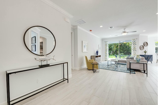 interior space featuring light wood-style floors, visible vents, and ornamental molding