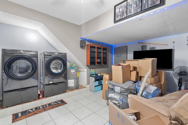 laundry room featuring tile patterned flooring, water heater, laundry area, a textured ceiling, and separate washer and dryer