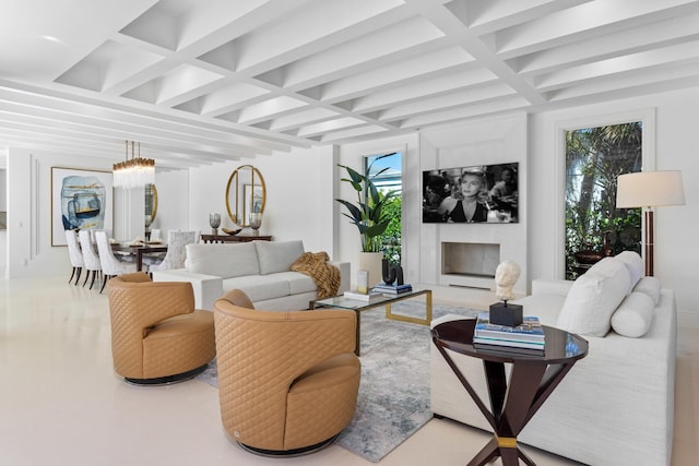 living area with a baseboard radiator, beam ceiling, coffered ceiling, and a high end fireplace