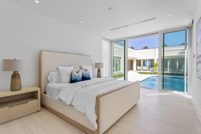 bedroom featuring recessed lighting, floor to ceiling windows, light wood-style floors, and access to outside