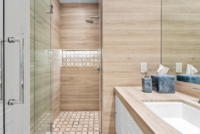 bathroom with a stall shower and vanity