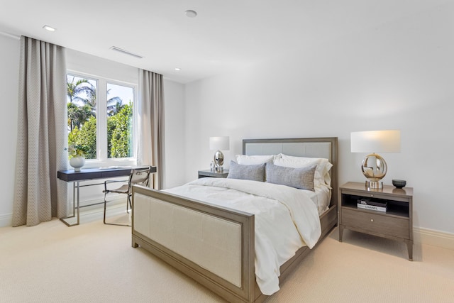 bedroom featuring visible vents, baseboards, and light colored carpet