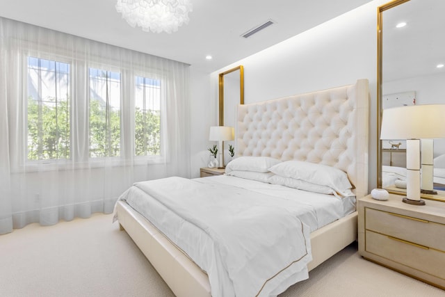 bedroom with recessed lighting, visible vents, light carpet, and a notable chandelier