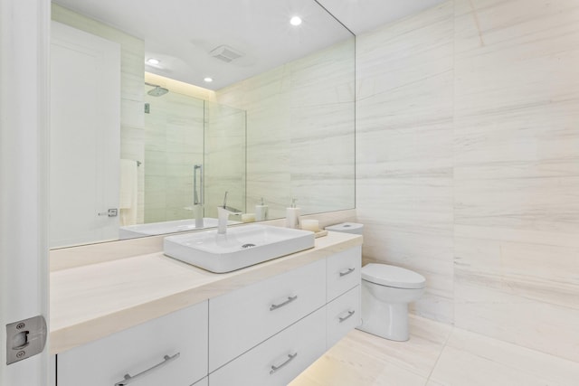 full bathroom with vanity, toilet, tile walls, and a shower stall