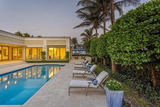 1740 S Ocean Blvd, Palm Beach, FL 33480 - pool at dusk with a patio area, an outdoor pool, and a gazebo