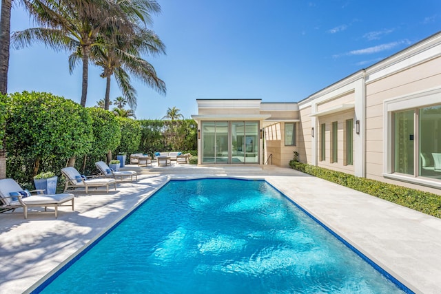 view of pool with an outdoor living space, a fenced in pool, and a patio