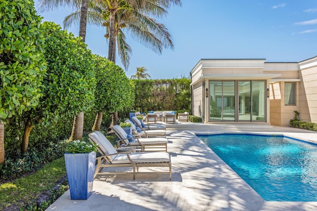 pool featuring an outdoor living space and a patio