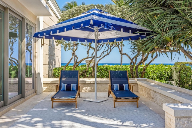 view of patio with a water view