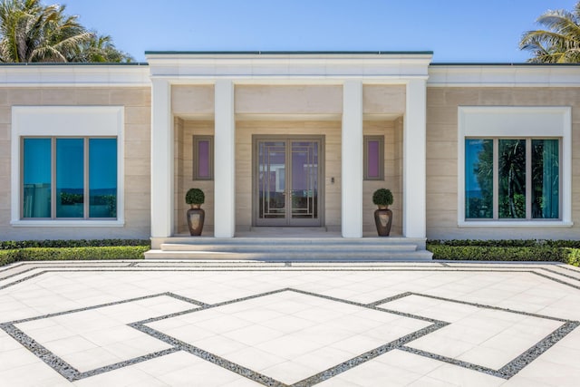 doorway to property featuring french doors and covered porch