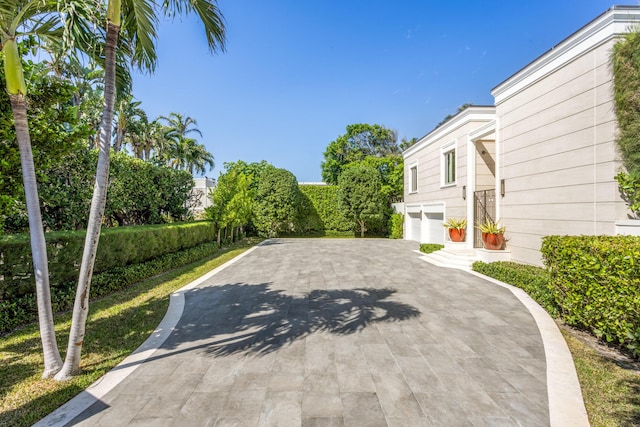 view of patio / terrace featuring driveway and a garage