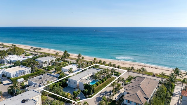 drone / aerial view featuring a water view and a view of the beach