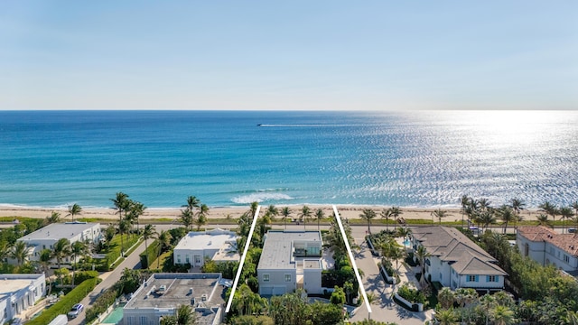 drone / aerial view featuring a beach view and a water view