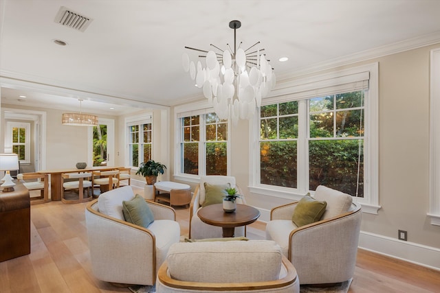 sunroom / solarium featuring visible vents and a chandelier