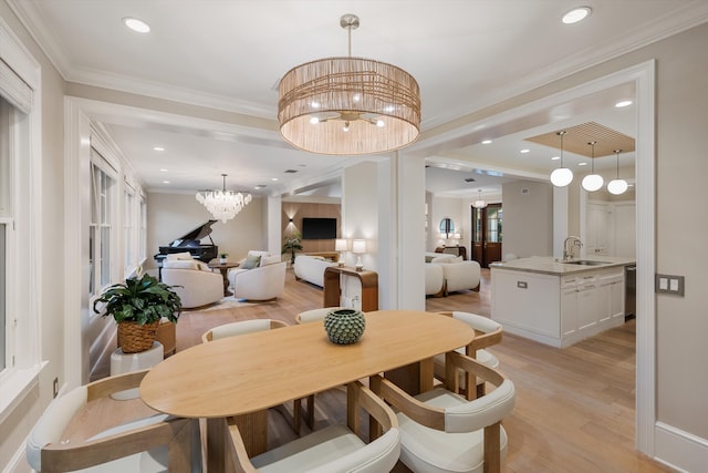 dining space featuring recessed lighting, an inviting chandelier, crown molding, and light wood finished floors