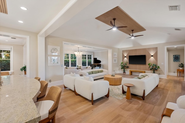 living area with recessed lighting, visible vents, light wood-style flooring, and ceiling fan with notable chandelier