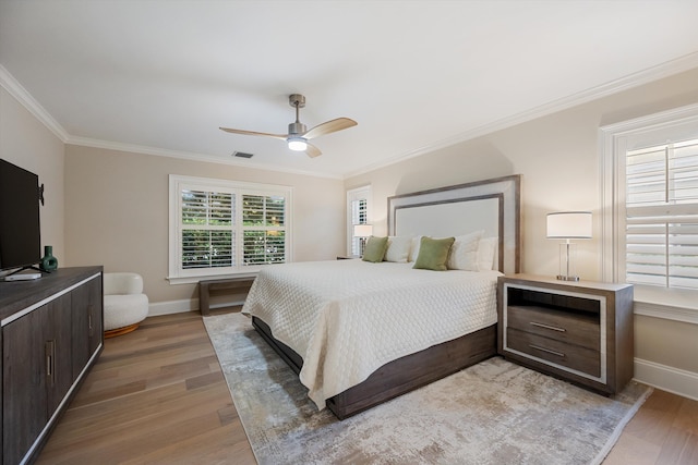 bedroom featuring visible vents, baseboards, and light wood finished floors