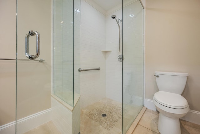 full bath featuring tile patterned floors, tiled shower, toilet, and baseboards