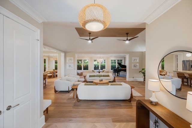 living room featuring a ceiling fan, crown molding, light wood-style floors, and high vaulted ceiling