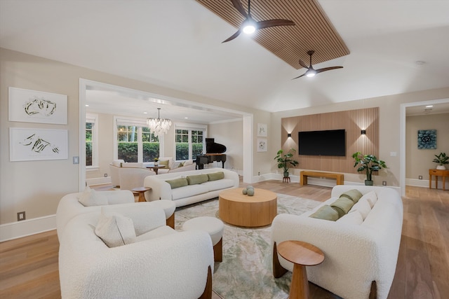 living area featuring recessed lighting, baseboards, wood finished floors, and ceiling fan with notable chandelier