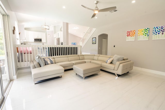 living room with recessed lighting, visible vents, arched walkways, and vaulted ceiling