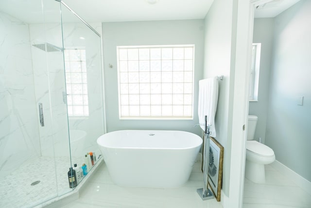 full bath with toilet, baseboards, a marble finish shower, and a freestanding bath