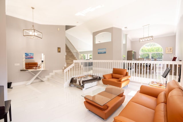 living area with baseboards, a notable chandelier, ornamental molding, and stairs