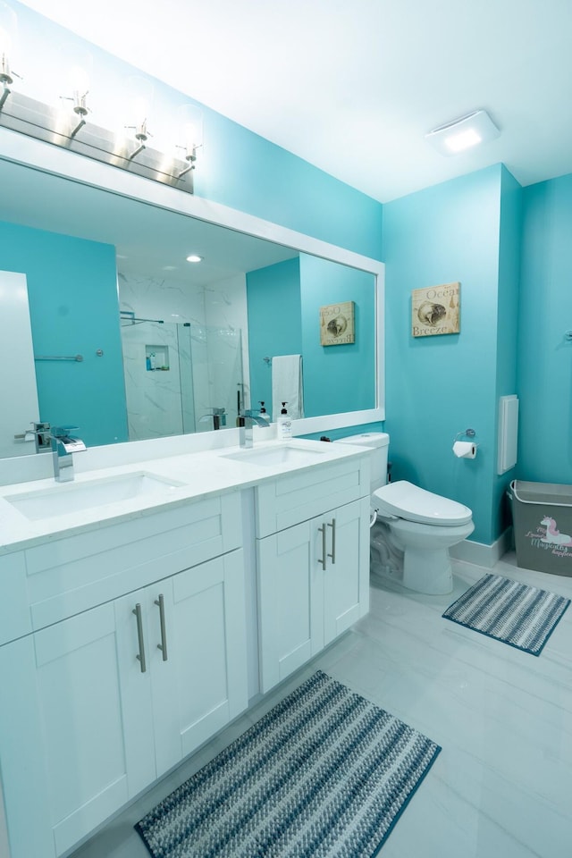 full bath featuring a sink, a marble finish shower, toilet, and double vanity