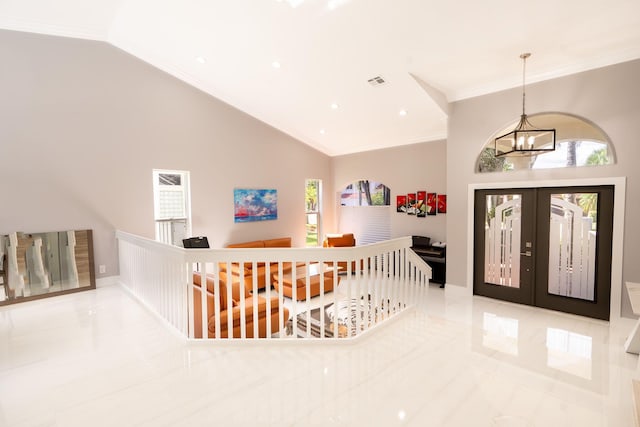 foyer entrance with visible vents, crown molding, french doors, a notable chandelier, and high vaulted ceiling