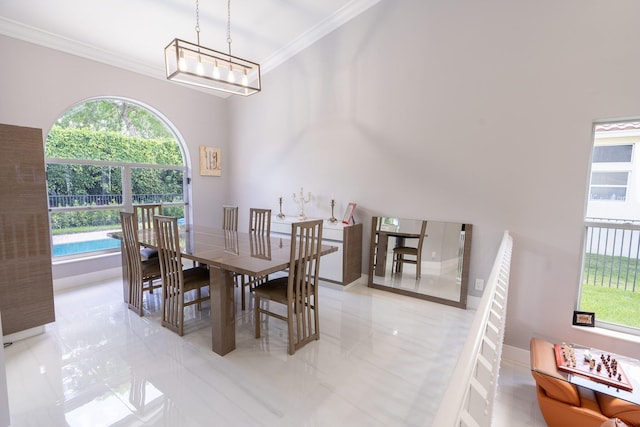 dining space with a wealth of natural light, baseboards, crown molding, and an inviting chandelier