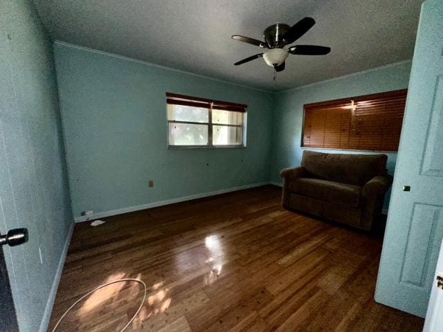 sitting room featuring a ceiling fan, wood finished floors, and baseboards