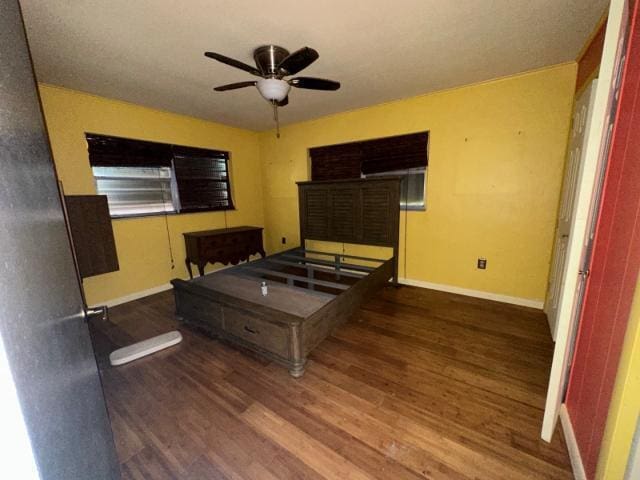 bedroom with wood finished floors and baseboards