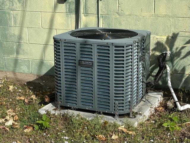 exterior details with central air condition unit and concrete block siding