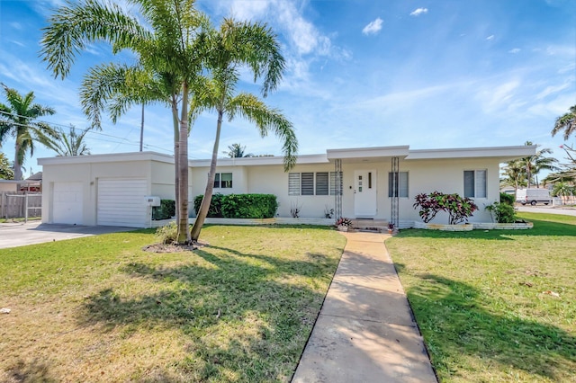 ranch-style house with a front lawn, fence, stucco siding, driveway, and an attached garage