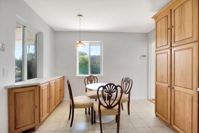 dining space featuring light tile patterned floors and baseboards