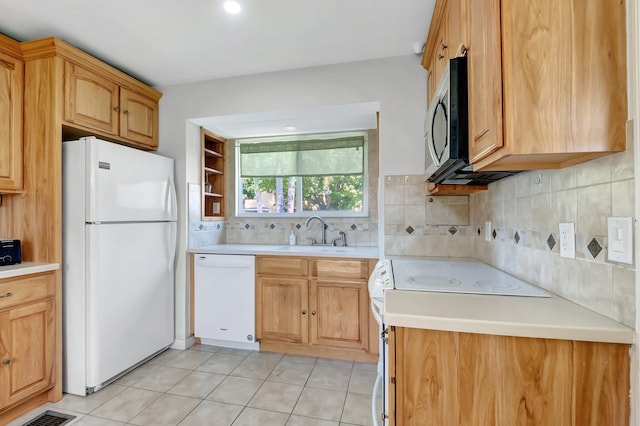 kitchen with visible vents, a sink, backsplash, white appliances, and light tile patterned flooring