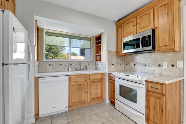 kitchen featuring a sink, white appliances, light tile patterned flooring, light countertops, and decorative backsplash