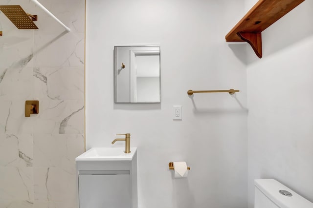 bathroom featuring a shower, toilet, and vanity