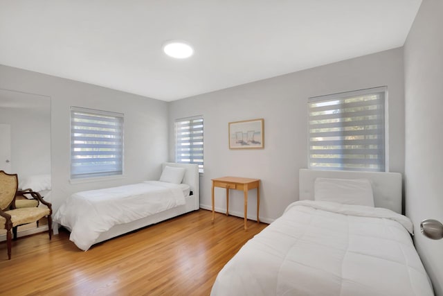 bedroom featuring baseboards and wood finished floors