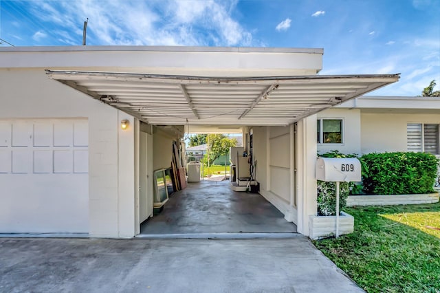 view of car parking featuring a carport, heating unit, and concrete driveway