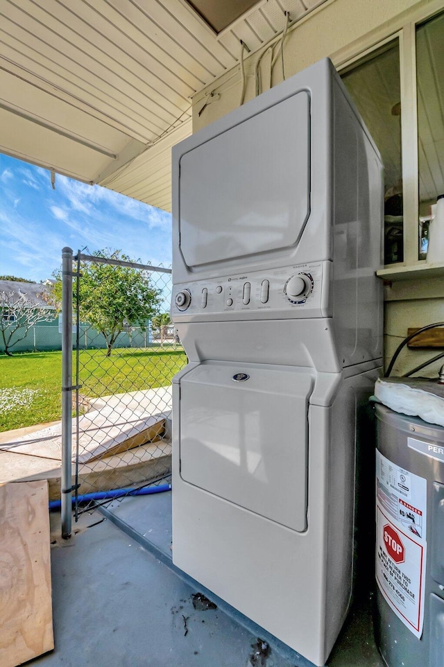 laundry area featuring stacked washer / drying machine